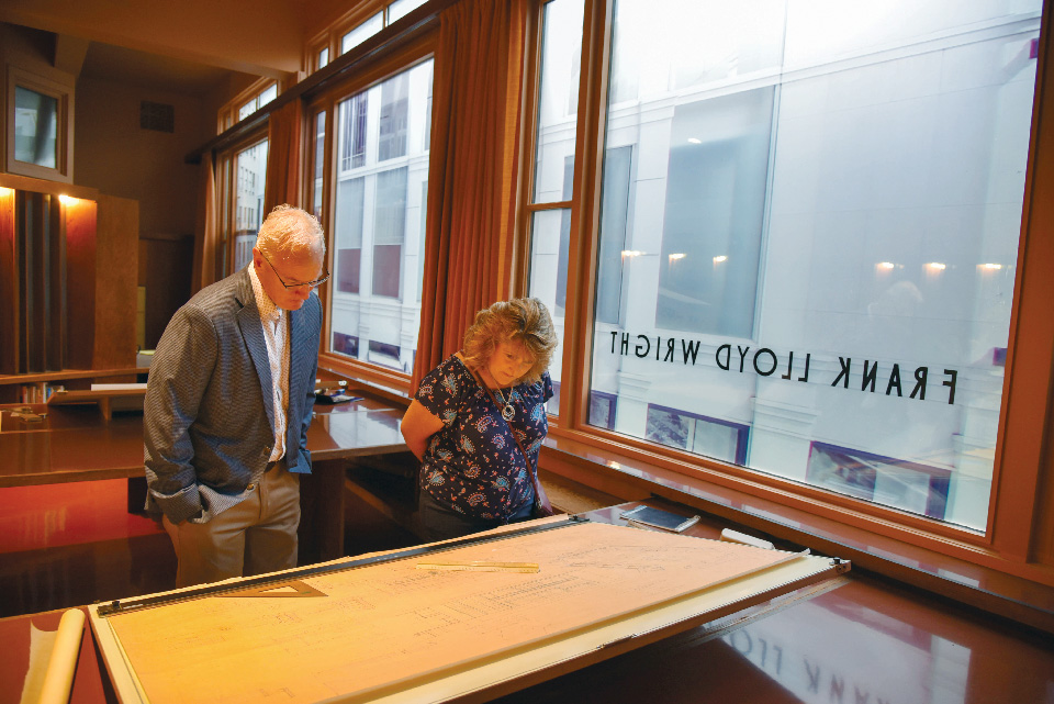 People looking at blueprints at re-creation of Frank Lloyd Wright’s San Fransisco office in Erie, Pennsylvania (photo courtesy of Hagen History Center) People looking at blueprints at re-creation of Frank Lloyd Wright’s San Fransisco office in Erie, Pennsylvania (photo courtesy of Hagen History Center)