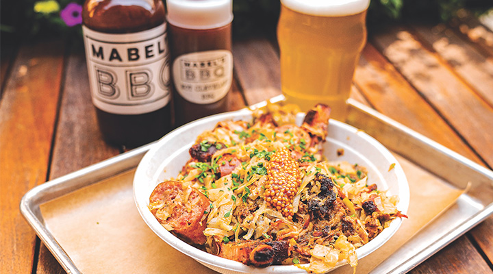 Barbecue dish with sauces and beer at Mabel's BBQ in Cleveland, Ohio (photo by Dustin Johnson) Barbecue dish with sauces and beer at Mabel's BBQ in Cleveland, Ohio (photo by Dustin Johnson)