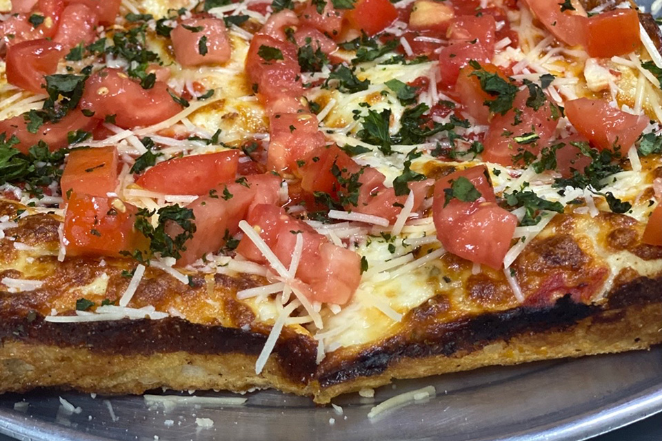 Pizza with tomatoes and herbs from Cloverleaf Pizza in Detroit, Michigan (photo courtesy of Cloverleaf Pizza) Pizza with tomatoes and herbs from Cloverleaf Pizza in Detroit, Michigan (photo courtesy of Cloverleaf Pizza)